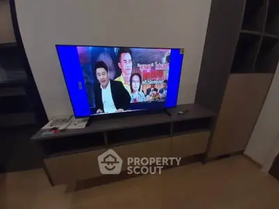 Modern living room with sleek TV stand and flat-screen television, perfect for entertainment.