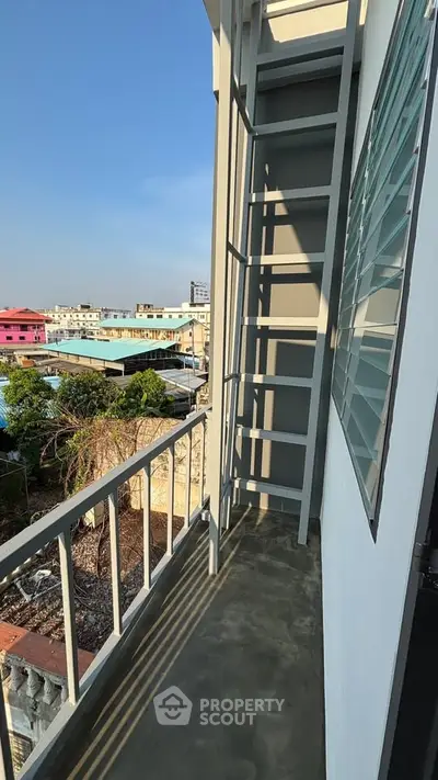 Charming balcony with city view, perfect for relaxation and enjoying the urban landscape.