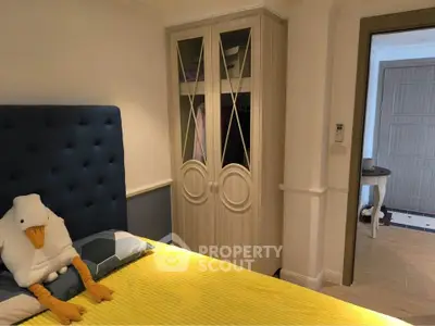 Cozy bedroom with stylish wardrobe and plush decor in modern apartment