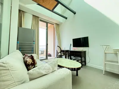 Spacious living room with modern decor and balcony access