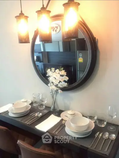 Elegant dining area with modern lighting and stylish table setting, perfect for intimate gatherings.
