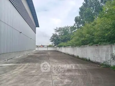 Spacious industrial property with ample outdoor space and secure perimeter fencing.