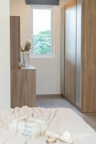 Cozy bedroom with wooden wardrobe and window view