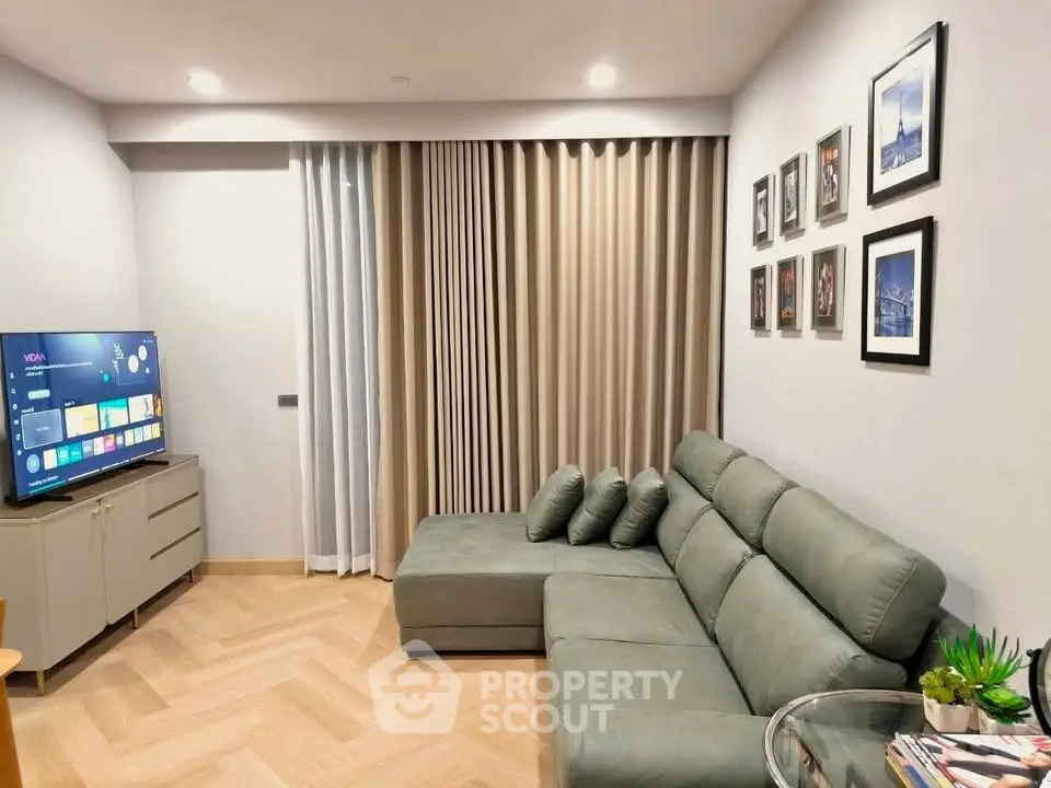 Modern living room with sleek sectional sofa and wall-mounted TV, perfect for cozy relaxation.