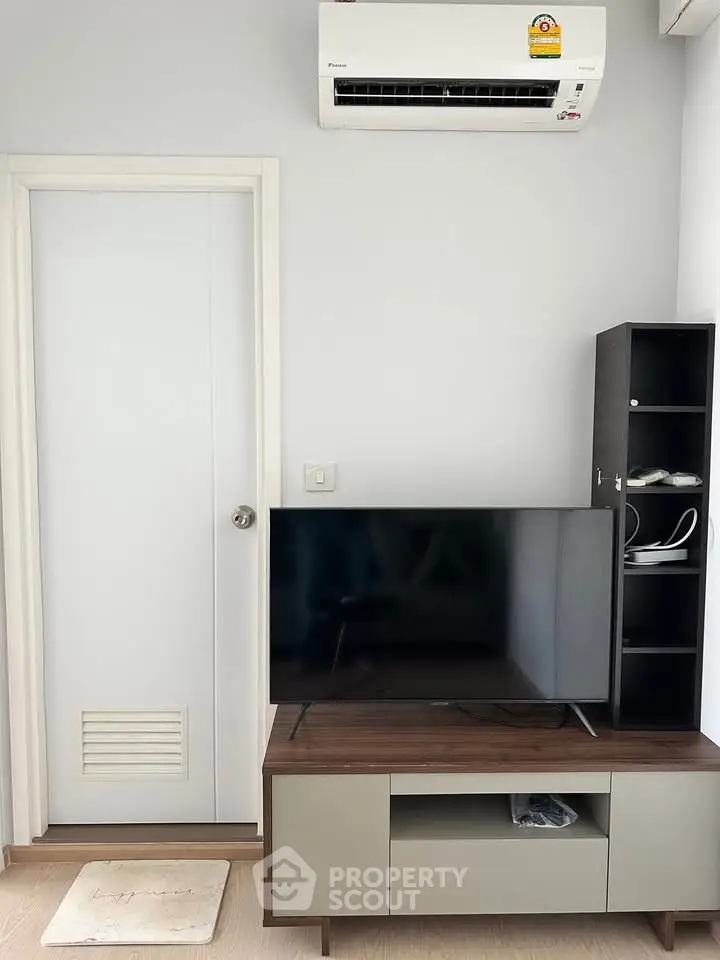 Modern living room with sleek TV stand and air conditioning unit, perfect for cozy entertainment.