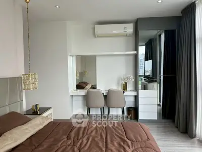 Modern bedroom with stylish decor and mirrored wardrobe in a luxury apartment.
