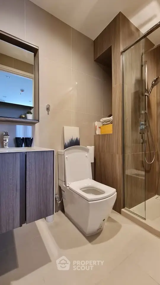 Modern bathroom with sleek design, featuring a glass shower and stylish vanity.