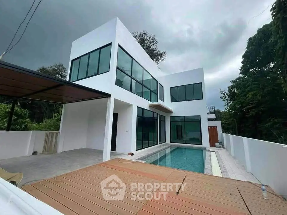 Modern minimalist white house with large windows and private pool