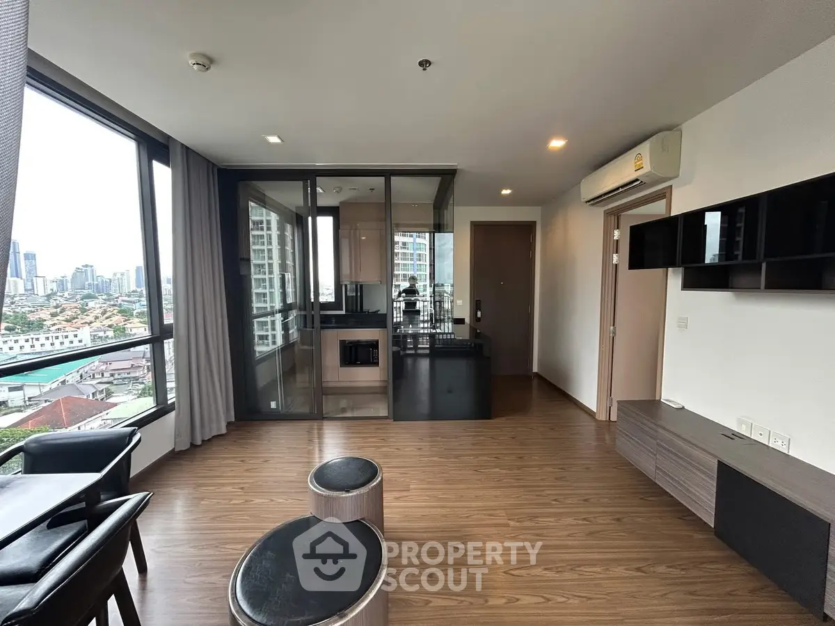 Modern living room with city view and sleek wooden flooring