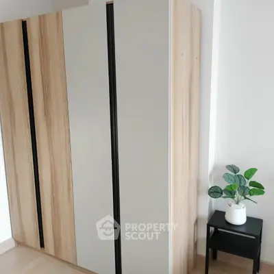 Modern minimalist wardrobe in stylish bedroom corner with plant decor