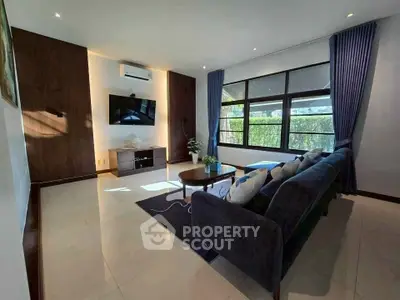 Spacious modern living room with large windows and elegant decor