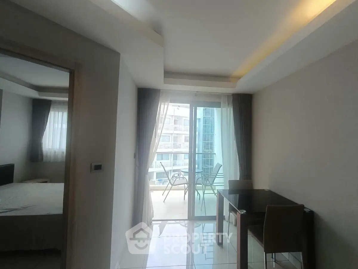 Modern apartment interior with balcony view and dining area