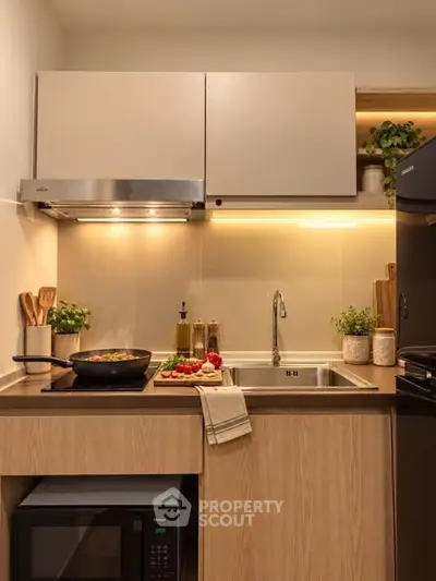 Modern kitchen with sleek cabinetry, stainless steel appliances, and ambient lighting.