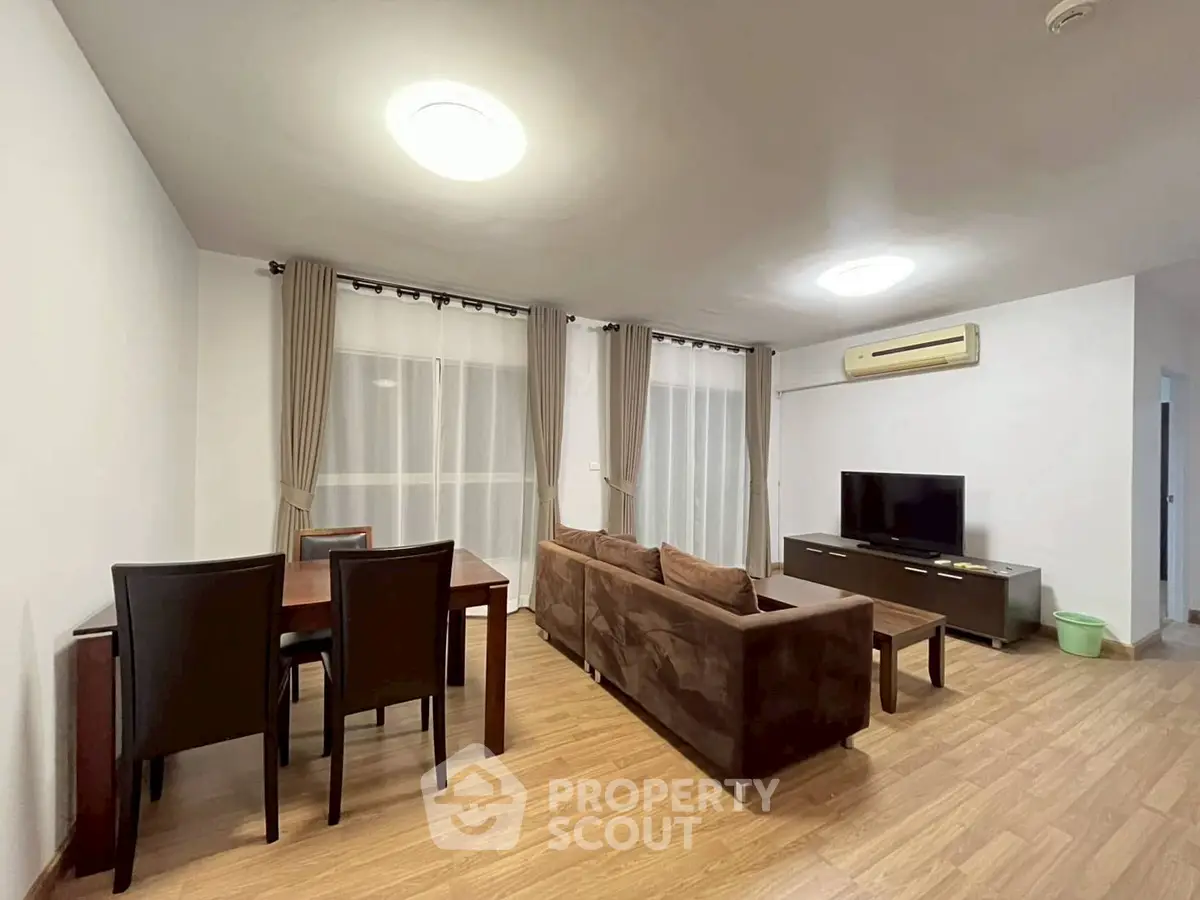 Spacious living room with modern furniture and wooden flooring