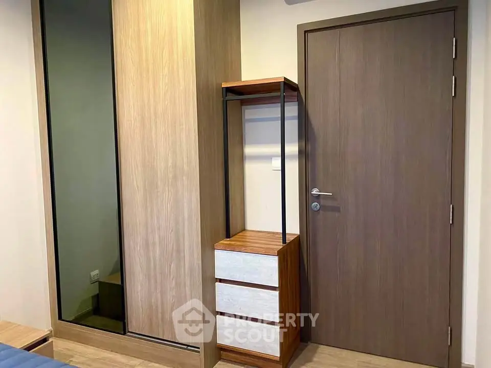 Modern bedroom with sleek wooden wardrobe and stylish dresser
