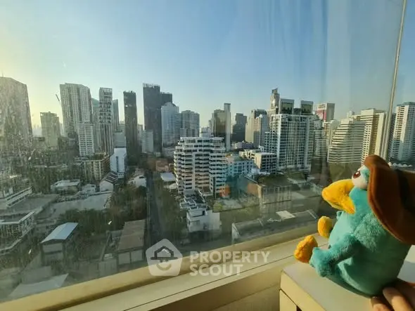 Stunning cityscape view from high-rise window with plush toy accent