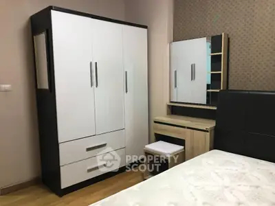 Modern bedroom with sleek wardrobe and stylish vanity set