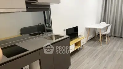 Modern studio apartment with sleek kitchen and cozy dining area