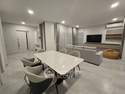 Spacious modern living room with elegant dining area and cozy seating, perfect for entertaining.