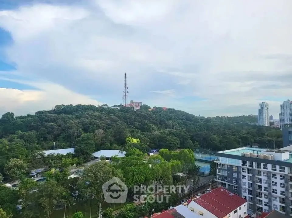 Stunning cityscape view with lush greenery and modern buildings.