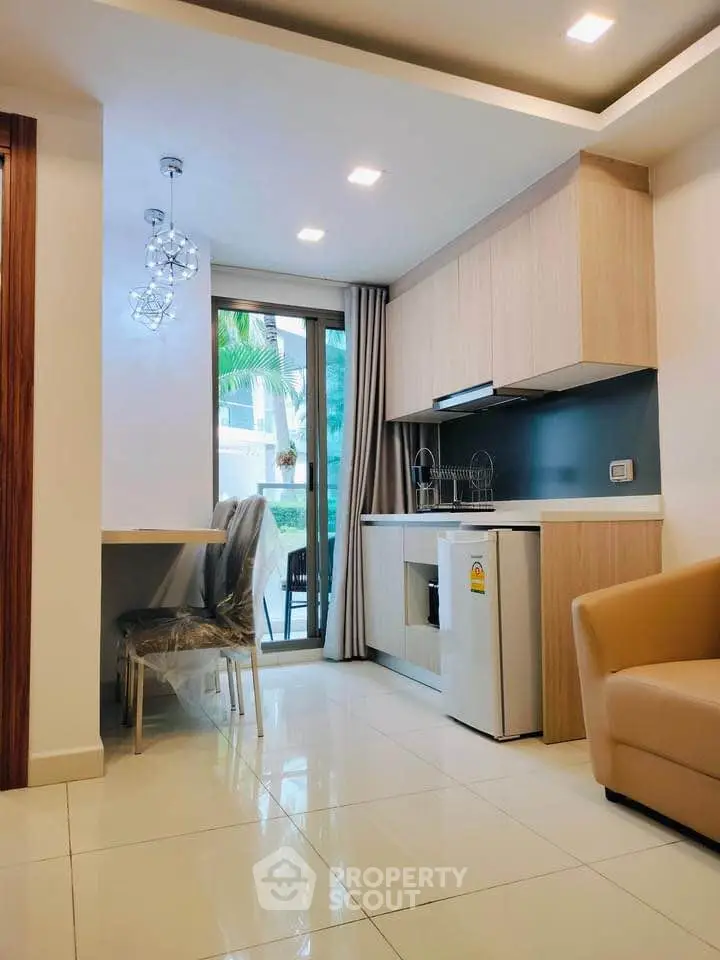 Modern kitchen with open layout and stylish lighting in a cozy apartment.