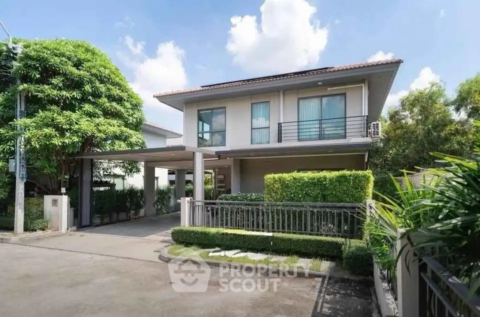 Modern two-story house with lush greenery and spacious driveway