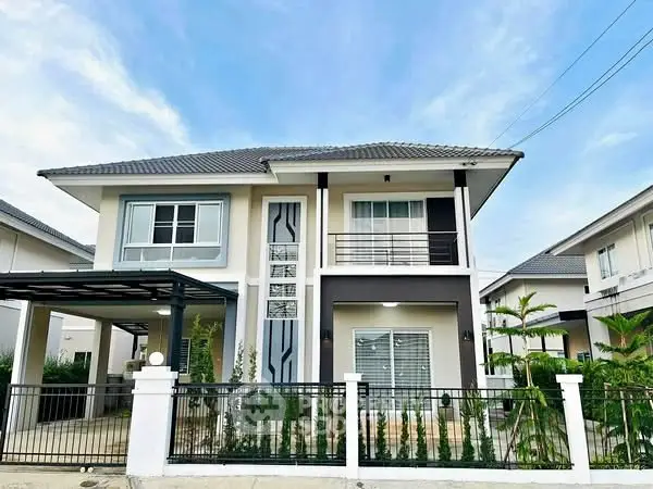 Modern two-story house with sleek design and spacious driveway in a suburban neighborhood.