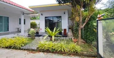 Charming single-story home with lush garden and modern exterior design.