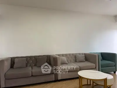 Spacious living room with elegant sofas and modern coffee table, perfect for relaxation.