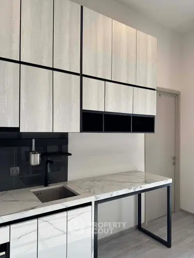 Modern kitchen with sleek cabinetry and marble countertops