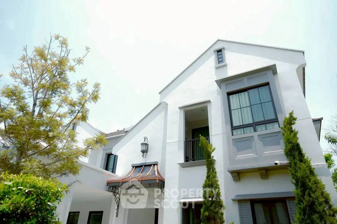 Elegant white house with modern architecture and lush greenery