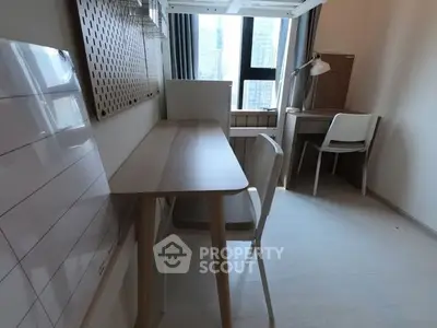 Modern study room with sleek desk and chair, large window offering city view, perfect for productivity.