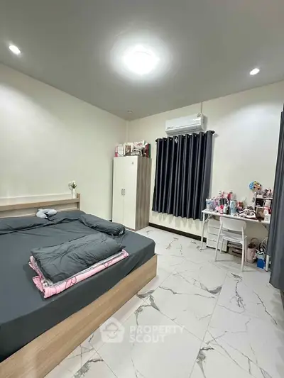 Modern bedroom with sleek design, featuring a comfortable bed, stylish wardrobe, and a cozy study area.