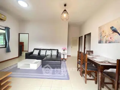 Spacious living room with modern decor and dining area in a bright apartment.