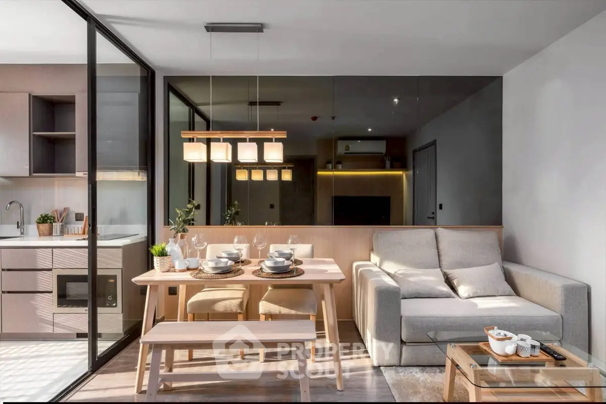 Modern open-plan living room with dining area and kitchen, featuring sleek furniture and stylish lighting.