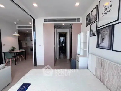 Modern bedroom with stylish decor and open layout leading to dining area, perfect for urban living.