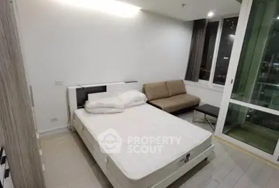 Modern bedroom with sleek design and large windows offering natural light.