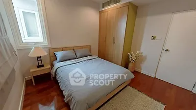 Cozy bedroom with wooden flooring and modern decor