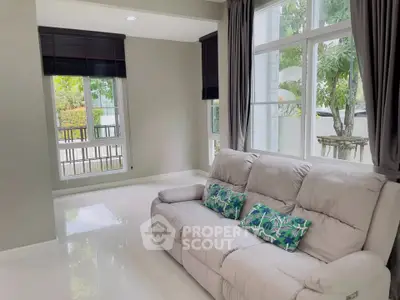 Bright living room with large windows and cozy sofa in modern home