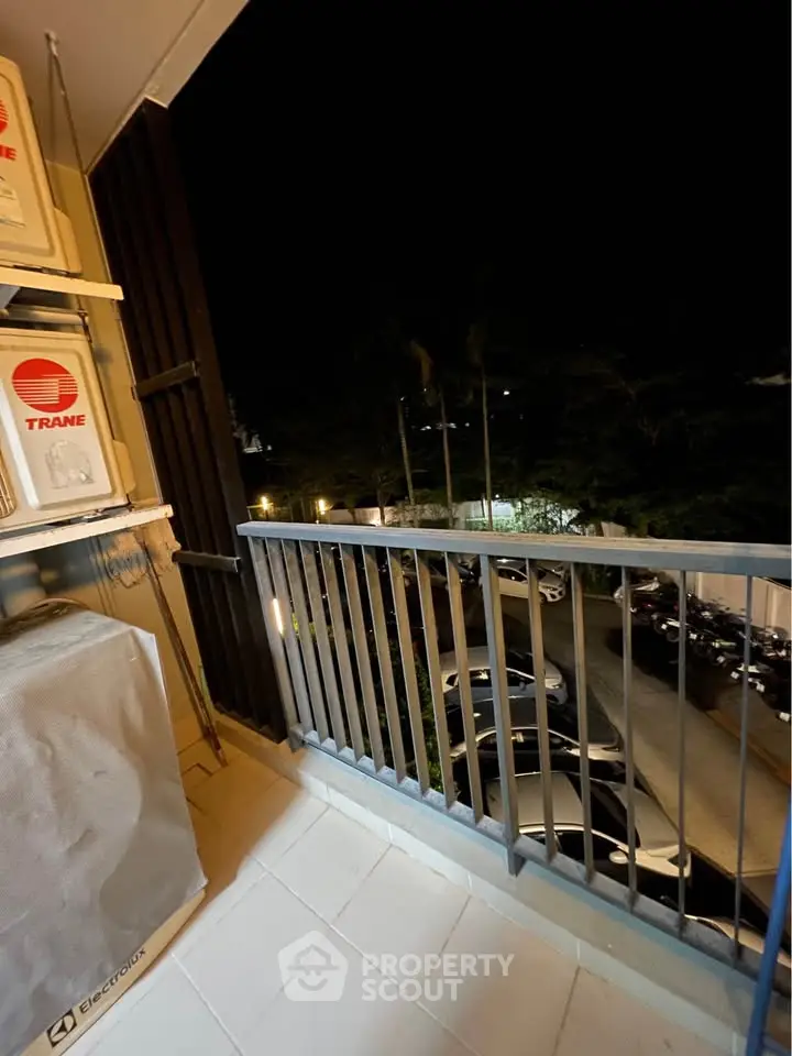 Charming balcony view with night ambiance, perfect for relaxation and enjoying the city lights.