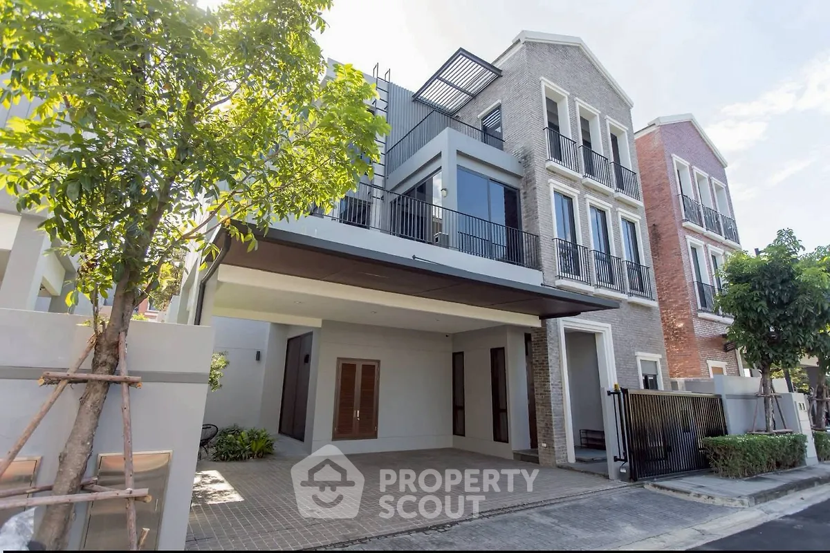 Modern three-story townhouse with spacious driveway and contemporary design.