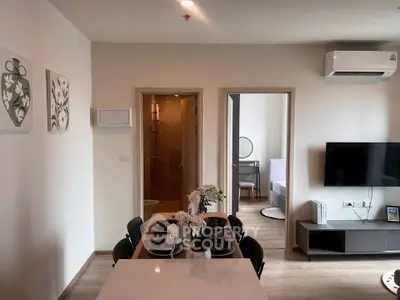 Modern apartment interior with dining area, TV, and air conditioning, showcasing a cozy and stylish living space.