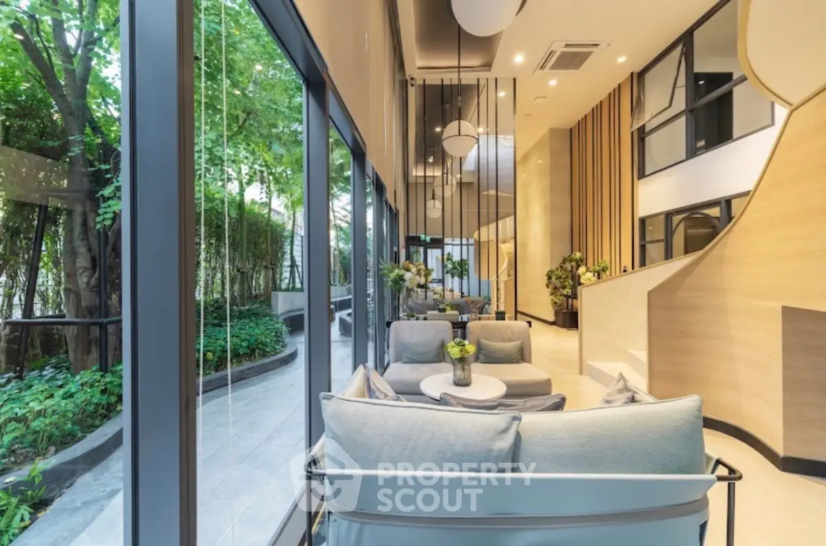Luxurious modern living room with floor-to-ceiling windows and lush garden view