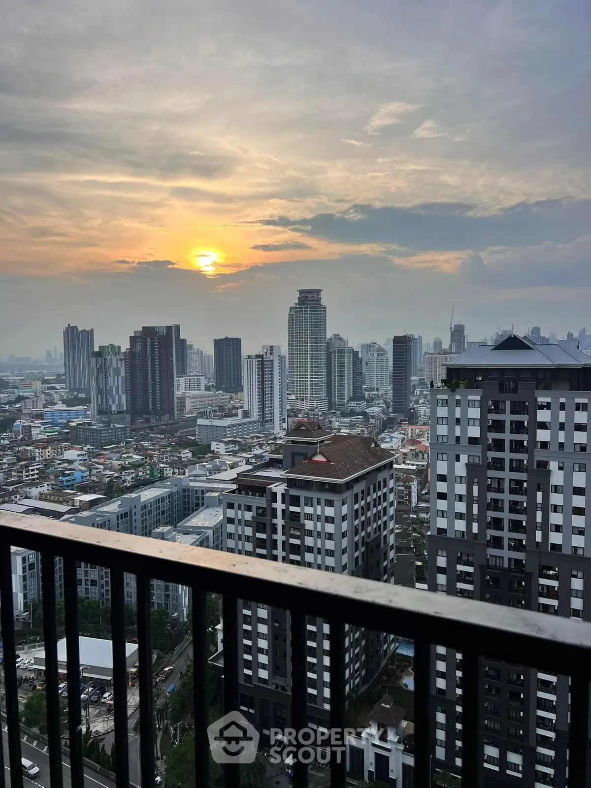 Stunning cityscape view from high-rise balcony at sunset