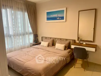 Cozy bedroom with modern decor and natural light in a stylish apartment.