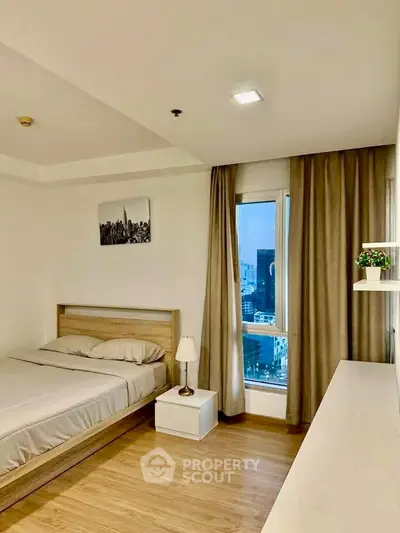 Modern bedroom with city view, wooden flooring, and minimalist decor.