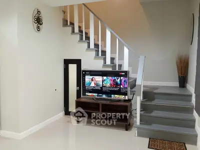 Modern interior with stylish staircase and entertainment area