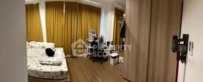 Cozy bedroom with modern decor and ample natural light