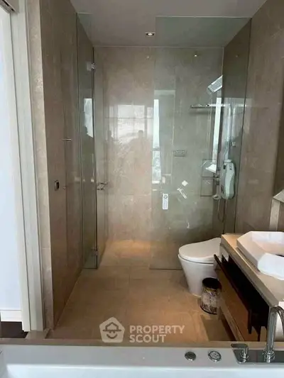 Luxurious modern bathroom with glass shower and elegant fixtures