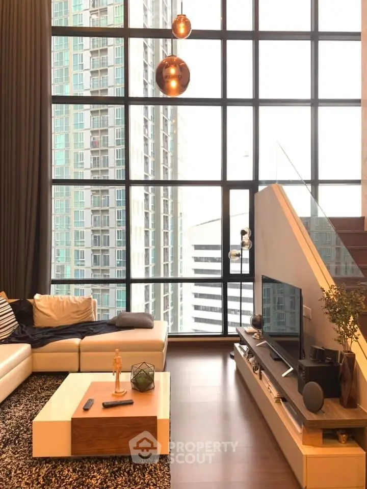 Luxurious living room with floor-to-ceiling windows and stunning city view